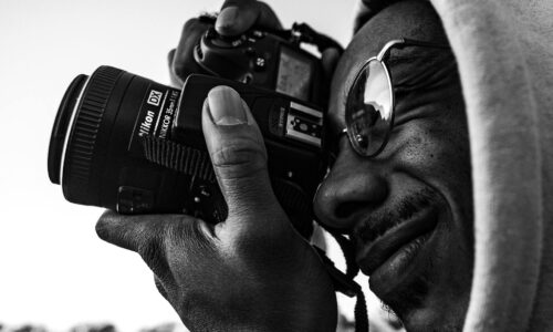 Ragazzo che scatta una foto con una reflex Nikon